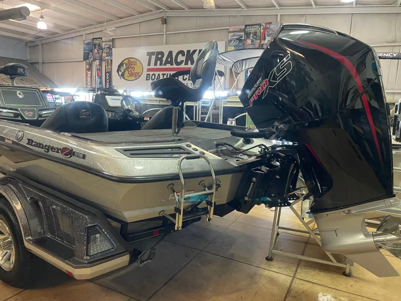 Slide: The Image of 2025 Ranger Z518 boat with powerful engine displayed in showroom. - 2
