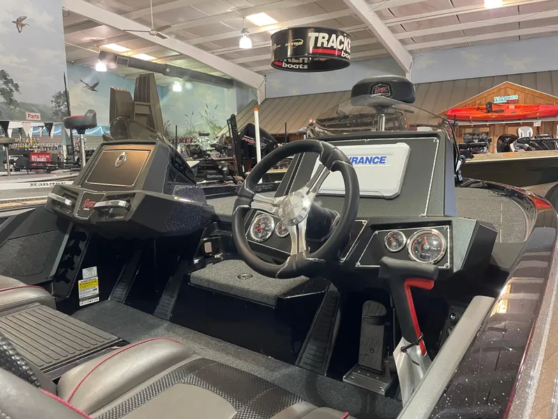 Slide: The Image of 2025 Ranger Z518 boat interior with steering wheel and dashboard in showroom. - 7