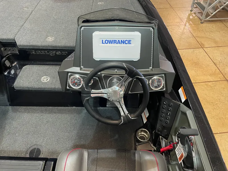 Slide: The Image of 2025 Ranger Z518 boat dashboard with Lowrance display and steering wheel. - 9