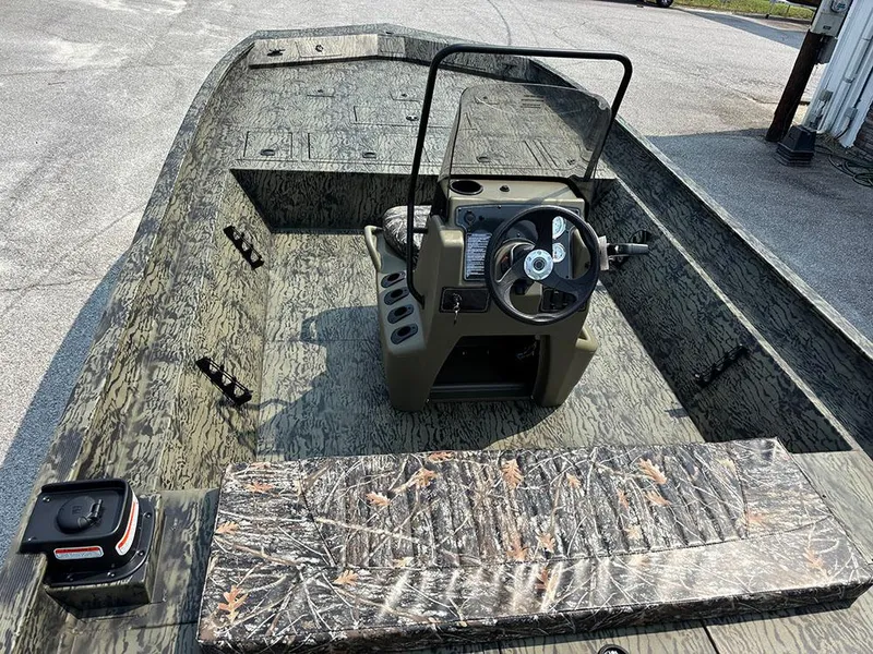 Slide: The Image of 2025 Tracker Grizzly 2072 CC boat with camouflage design and central steering console. - 10