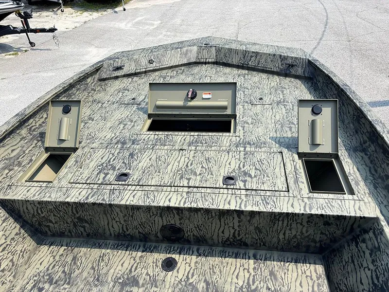 Slide: The Image of 2025 Tracker Grizzly 2072 CC boat with camo design and storage compartments. - 13