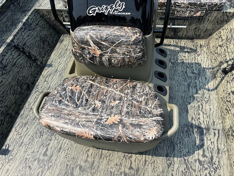 Slide: The Image of 2025 Tracker Grizzly 2072 CC boat with camouflage seating and textured flooring. - 15