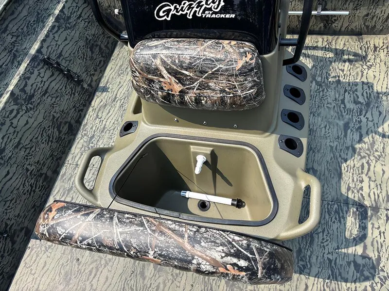 Slide: The Image of 2025 Tracker Grizzly 2072 CC boat interior with camo seats and storage compartment. - 16