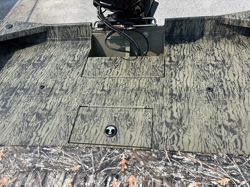Slide: The Image of 2025 Tracker Grizzly 2072 CC boat deck with camouflage pattern and storage compartments. - 19