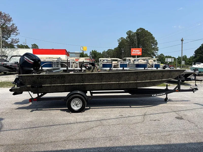 Slide: The Image of 2025 Tracker Grizzly 2072 CC boat on trailer in outdoor storage area. - 6
