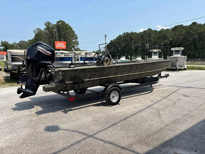 Slide: The Image of 2025 Tracker Grizzly 2072 CC boat with Mercury engine on trailer, parked outdoors. - 7