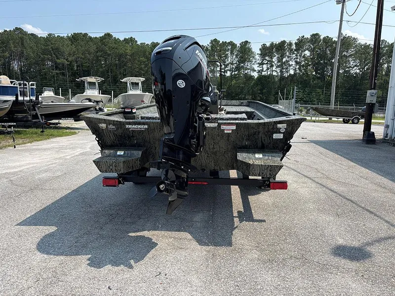 Slide: The Image of 2025 Tracker Grizzly 2072 CC boat with outboard motor, parked outdoors. - 8