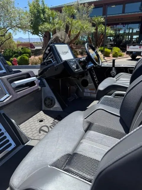 Slide: The Image of 2025 Ranger Z520R boat interior with modern dashboard and seating. - 12