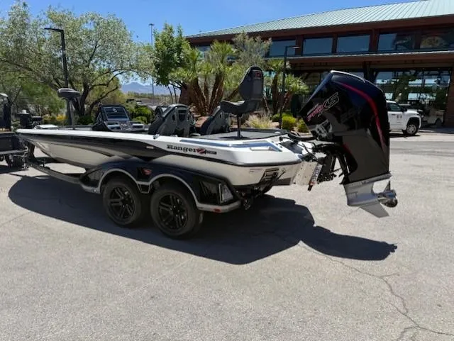Slide: The Image of 2025 Ranger Z520R boat with powerful outboard motor, parked outdoors on a sunny day. - 2