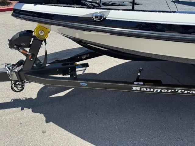 Slide: The Image of 2025 Ranger Z520R boat trailer with black frame and yellow wheel chock. - 4
