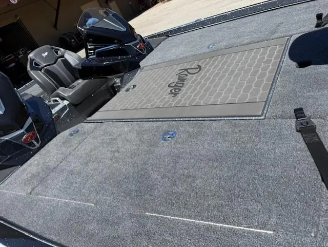 Slide: The Image of 2025 Ranger Z520R boat interior with gray carpet and seating. - 7