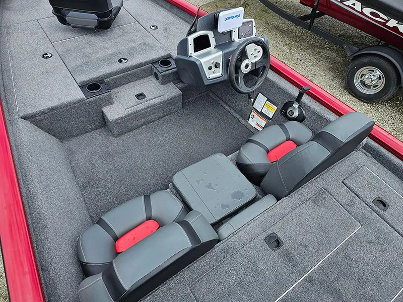 Slide: The Image of 2025 Tracker Pro Team 175 boat interior with gray and red seating, steering console, and storage compartments. - 10