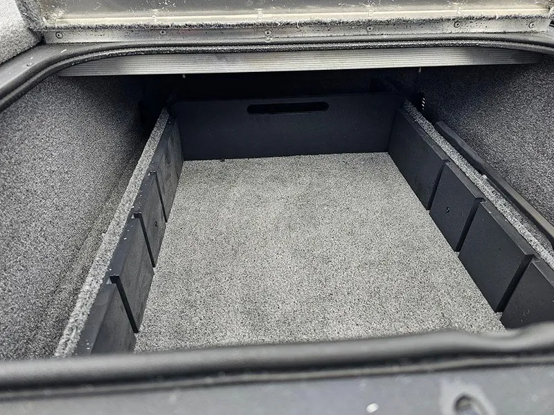 Slide: The Image of 2025 Tracker Pro Team 175 storage compartment with carpeted interior and organized dividers. - 18