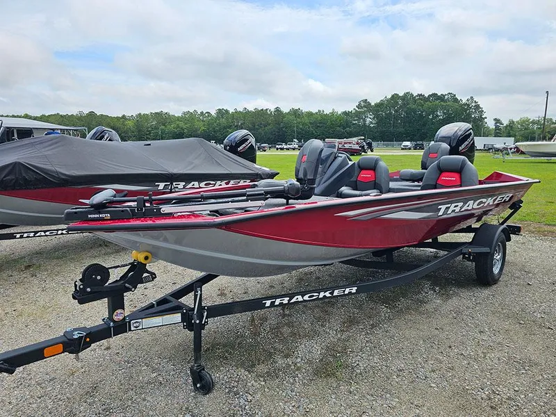 Slide: The Image of 2025 Tracker Pro Team 175 boat on trailer, red and gray design, parked outdoors. - 5