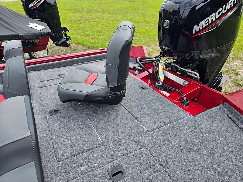 Slide: The Image of 2025 Tracker Pro Team 175 boat with Mercury engine and seating on a carpeted deck. - 8