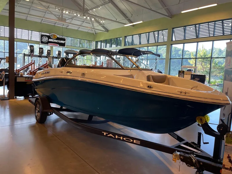Slide: The Image of 2025 Tahoe 200 S boat displayed indoors on a trailer. - 1