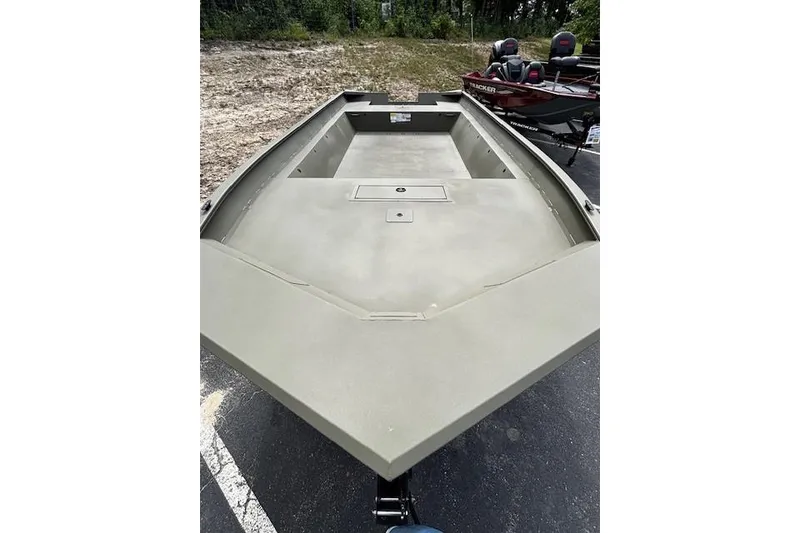 Slide: The Image of 2025 Tracker Grizzly 2072 Utility boat, spacious deck, parked outdoors. - 2