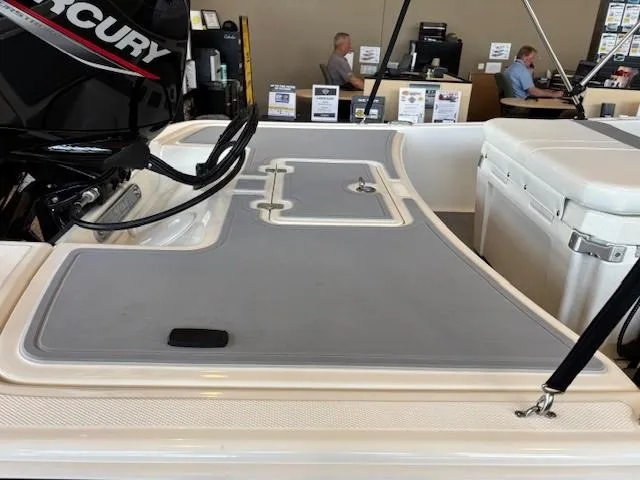 Slide: The Image of 2025 Mako Pro Skiff 17 CC boat interior with Mercury engine and storage compartments. - 9