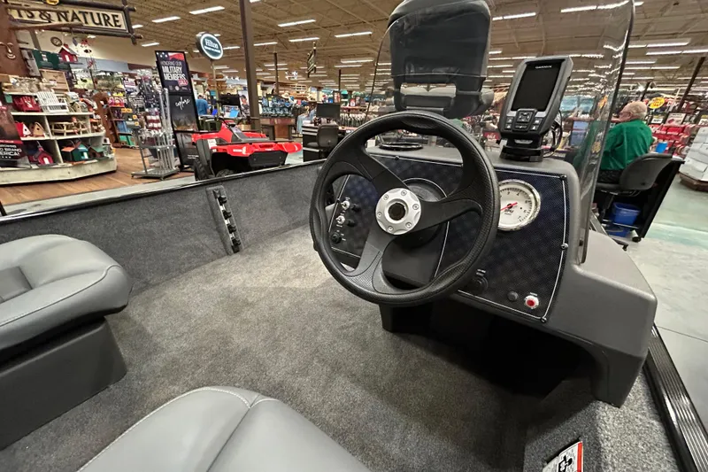Slide: The Image of 2025 Tracker Bass Tracker Classic XL boat interior with steering wheel and dashboard display. - 5