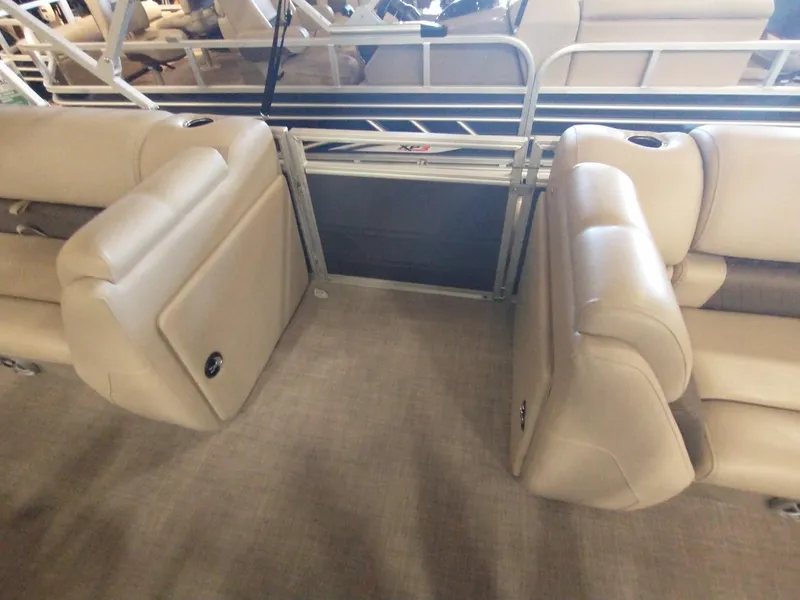 Slide: The Image of 2025 Sun Tracker Party Barge 20 DLX interior with beige seating and railing. - 3