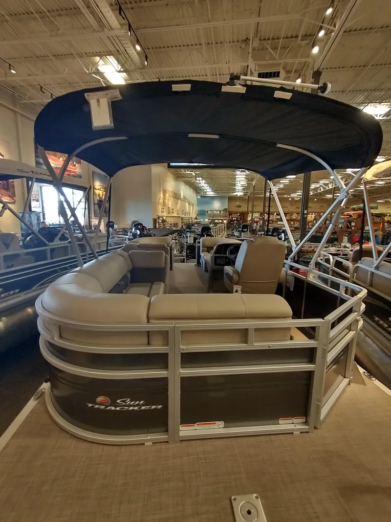 Slide: The Image of 2025 Sun Tracker Party Barge 20 DLX pontoon boat displayed indoors. - 4