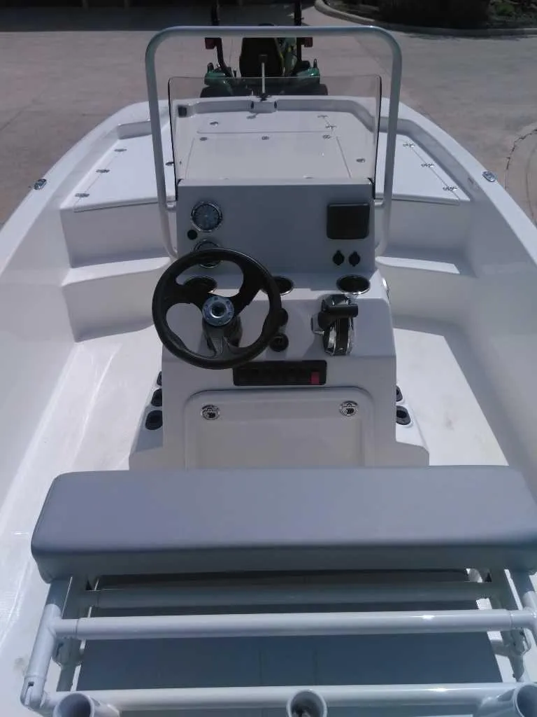 Slide: The Image of 2025 Mako Pro Skiff 19 CC boat interior with steering console and seating. - 4