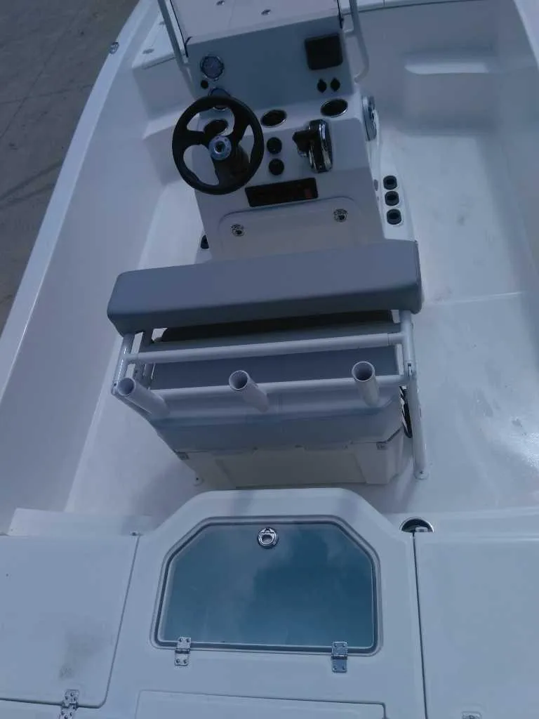 Slide: The Image of 2025 Mako Pro Skiff 19 CC boat interior with steering console and seating. - 5