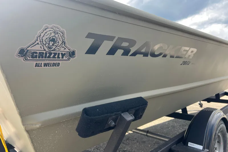 Slide: The Image of 2025 Tracker Grizzly 2072 Utility boat with "All Welded" logo, side view. - 11