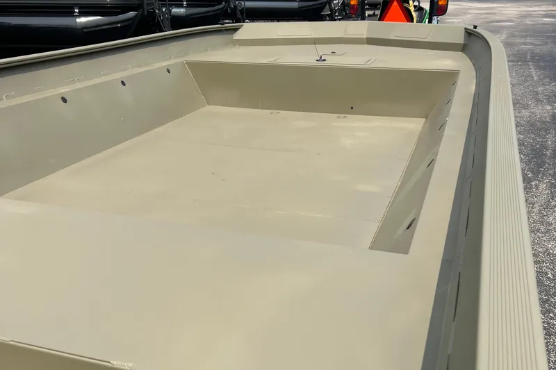 Slide: The Image of 2025 Tracker GRIZZLY 2072 Utility boat, spacious interior, beige color, parked outdoors. - 6