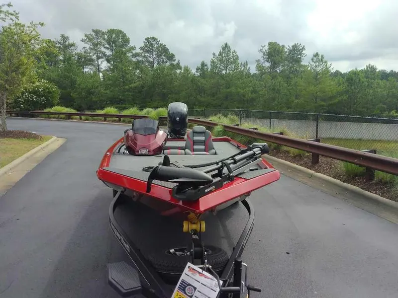 Slide: The Image of 2025 Ranger RT178C boat on trailer, parked on a paved road with trees in the background. - 3