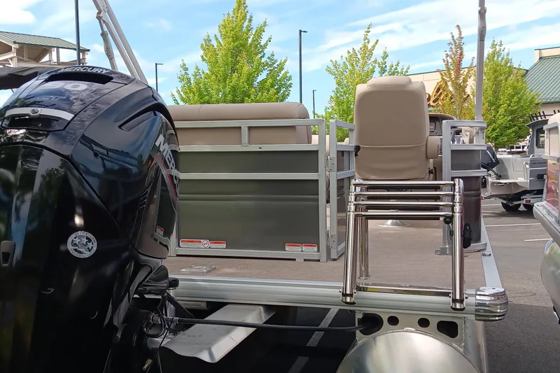 Slide: The Image of 2025 Sun Tracker Party Barge 20 DLX pontoon boat with Mercury engine in a parking lot. - 5