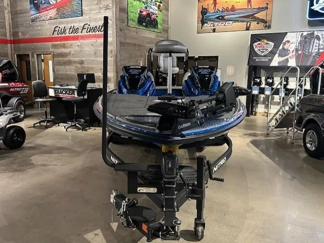 Slide: The Image of 2025 Nitro Z20 XL Pro boat displayed in a showroom with fishing equipment. - 17
