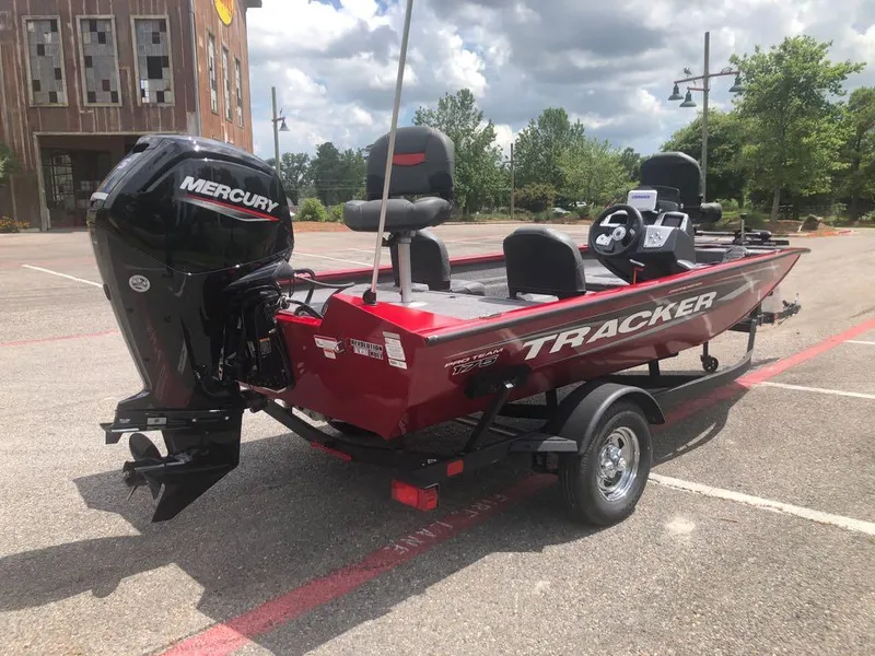 Slide: The Image of 2025 Tracker Pro Team 175 Crappie Edition boat with Mercury engine in a parking lot. - 11