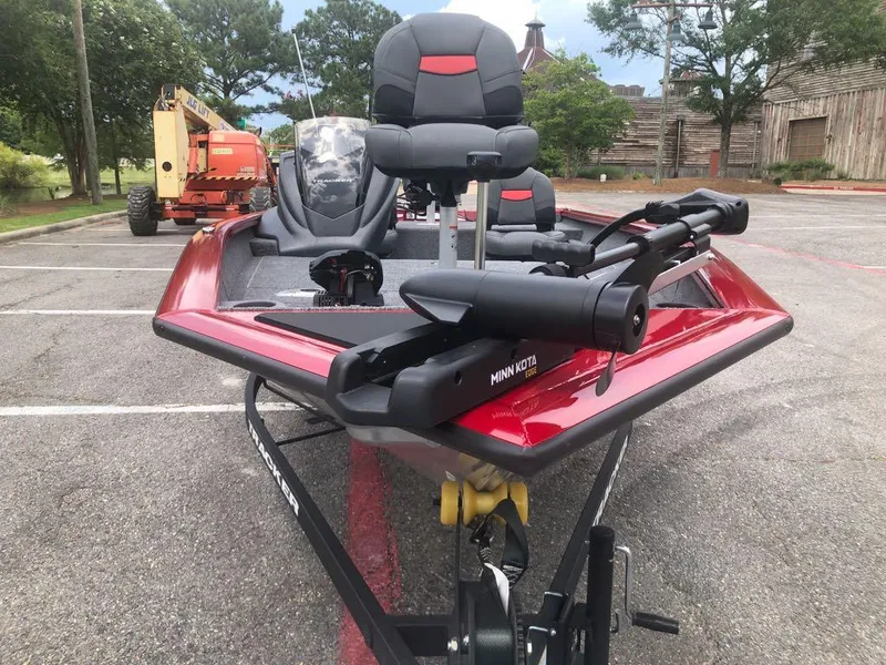 Slide: The Image of 2025 Tracker Pro Team 175 Crappie Edition boat with Minn Kota motor in a parking lot. - 2