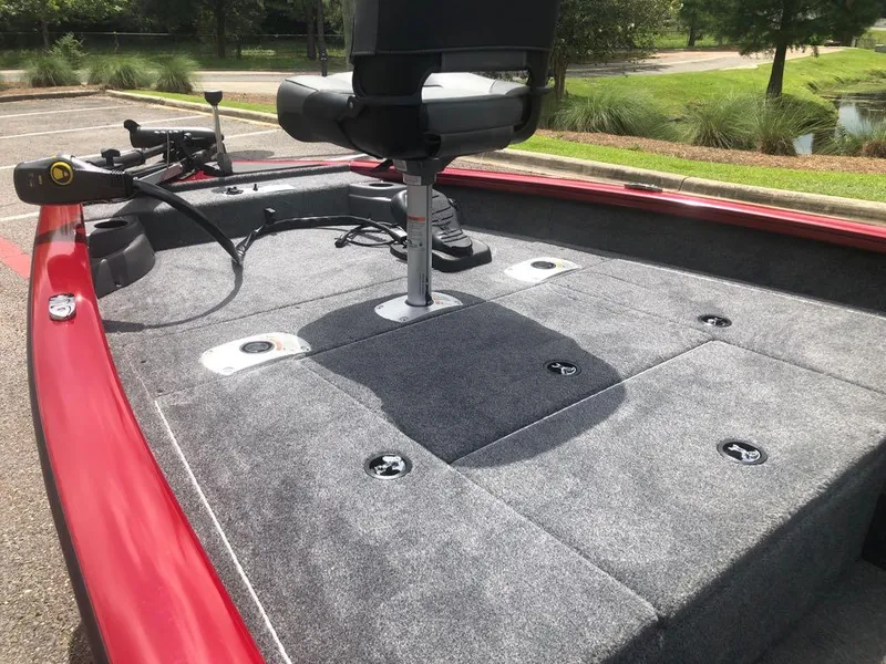 Slide: The Image of 2025 Tracker Pro Team 175 Crappie Edition boat with gray carpeted deck and swivel seat. - 4