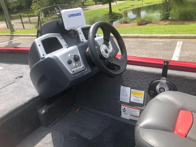 Slide: The Image of 2025 Tracker Pro Team 175 Crappie Edition boat interior with steering wheel and Lowrance display. - 6