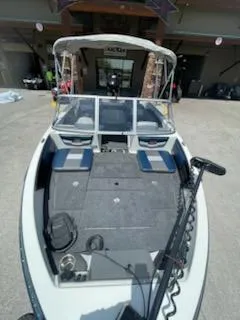 Slide: The Image of 2025 Ranger 1850MS boat with spacious deck and modern design in a showroom setting. - 13