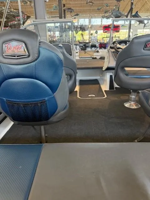 Slide: The Image of Interior of 2025 Ranger 1850MS boat with blue and gray seating. - 16