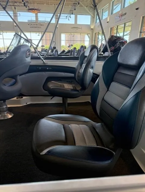 Slide: The Image of 2025 Ranger 1850MS boat interior with modern seating in a showroom setting. - 17