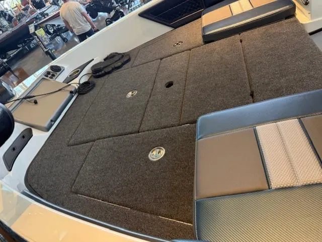 Slide: The Image of 2025 Ranger 1850MS boat interior with cushioned seating and storage compartments. - 19