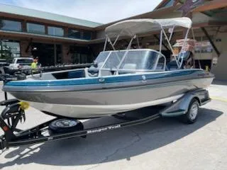 Slide: The Image of 2025 Ranger 1850MS boat on trailer, parked outdoors, with canopy and sleek design. - 3