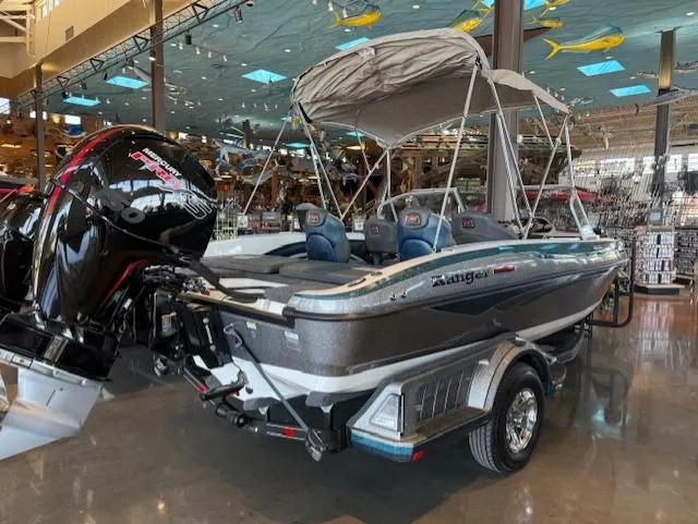 Slide: The Image of 2025 Ranger 1850MS boat with canopy and powerful outboard motor in showroom. - 4
