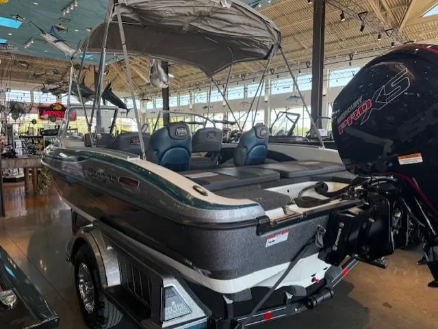 Slide: The Image of 2025 Ranger 1850MS boat with canopy and motor, displayed indoors. - 7