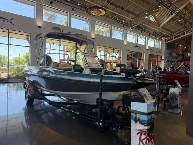 Slide: The Image of 2025 Ranger 1850MS boat displayed in a showroom with large windows and high ceilings. - 8