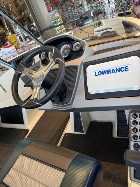 Slide: The Image of 2025 Ranger 1850MS boat dashboard with steering wheel and Lowrance navigation system. - 9