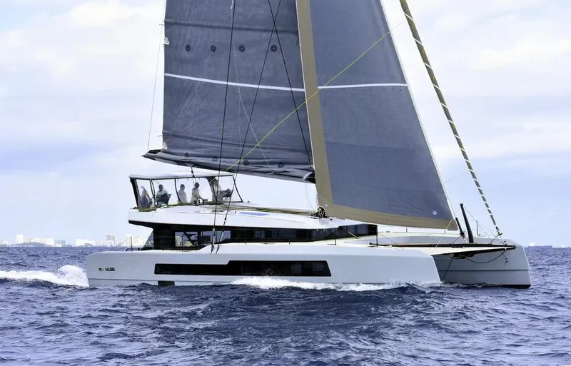 Slide: The Image of 2026 McConaghy MC62 sailing catamaran on open sea with crew onboard. - 1