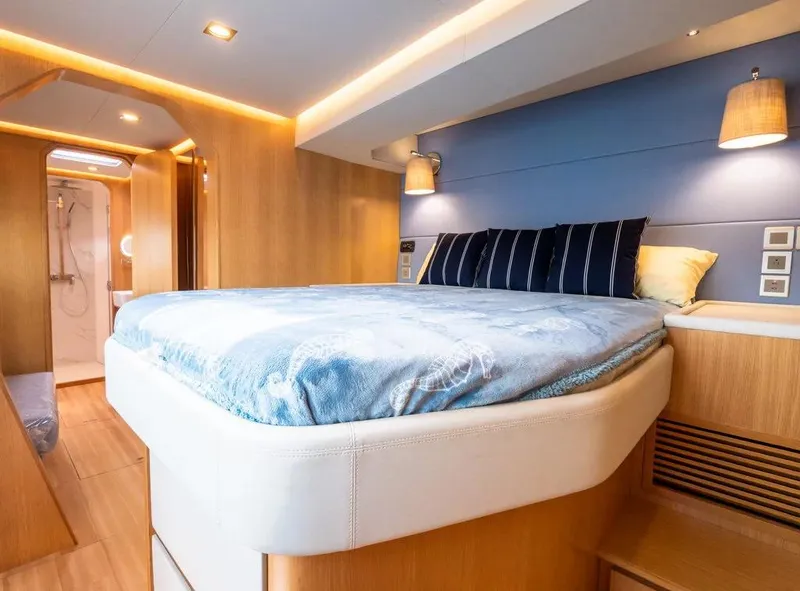 Slide: The Image of Luxurious bedroom interior of 2026 McConaghy MC62 yacht with modern lighting and cozy bedding. - 10