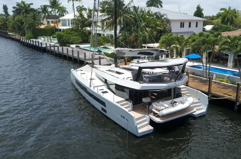 Slide: The Image of Luxury McConaghy MC62 yacht docked by waterfront homes, 2026 model. - 4