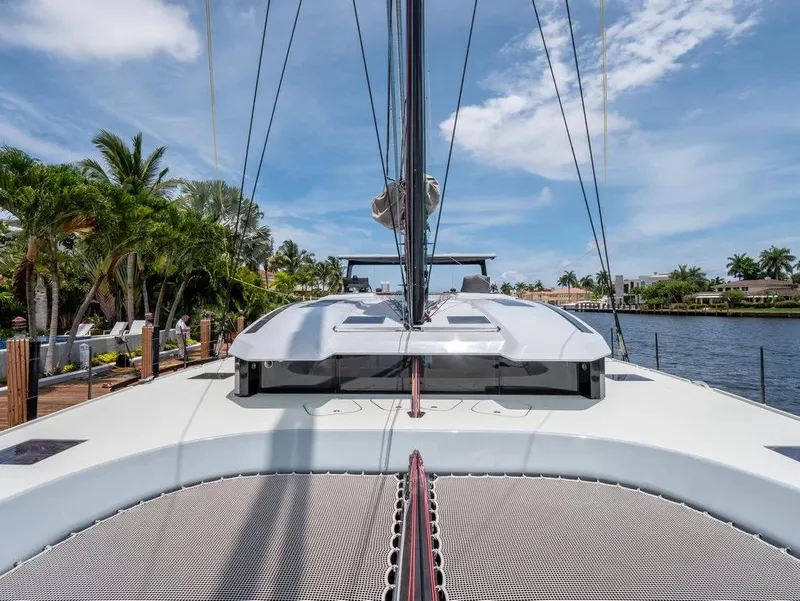 Slide: The Image of 2026 McConaghy MC62 yacht docked by palm trees under a clear blue sky. - 6