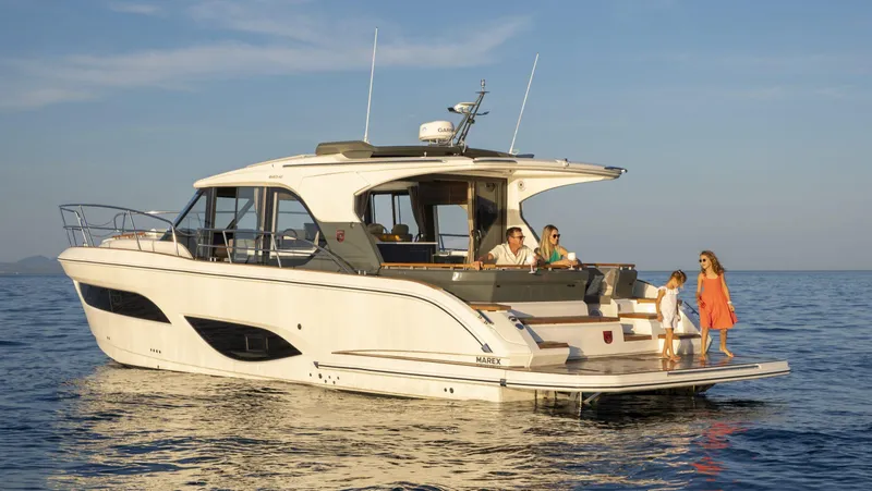 Slide: The Image of 2025 Marex 440 Gourmet Cruiser yacht on calm sea with people enjoying the deck. - 11
